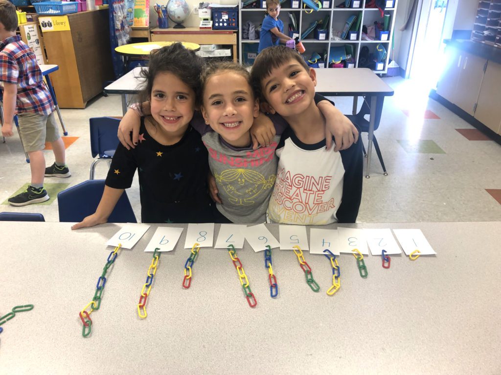Smiling students working on a counting activity